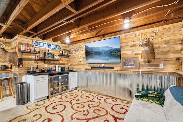 bar featuring bar, beverage cooler, and wood walls