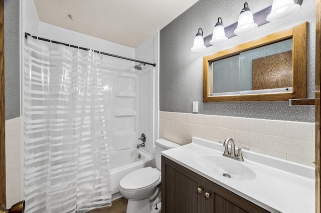 bathroom with vanity, a wainscoted wall, wallpapered walls, tile walls, and toilet