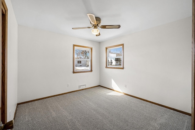 empty room featuring ceiling fan, baseboards, and carpet