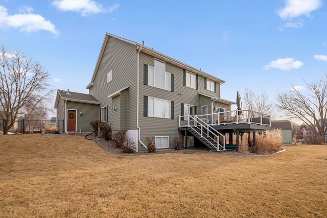 rear view of house featuring stairway, a yard, and a deck