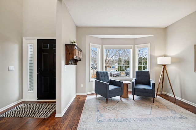 entryway featuring baseboards and wood finished floors