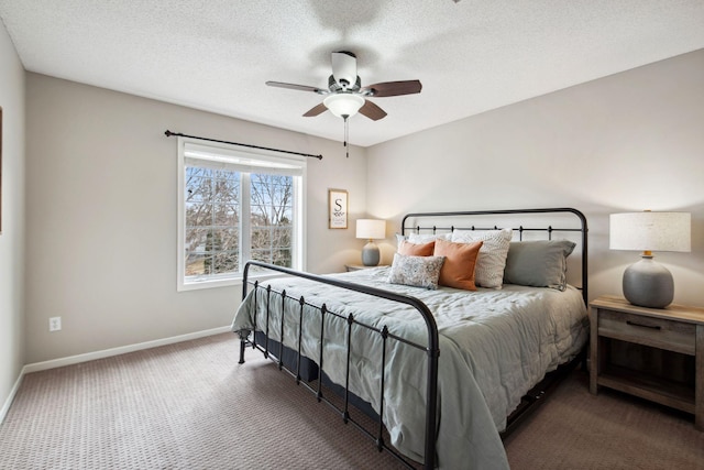 carpeted bedroom featuring ceiling fan, baseboards, and a textured ceiling