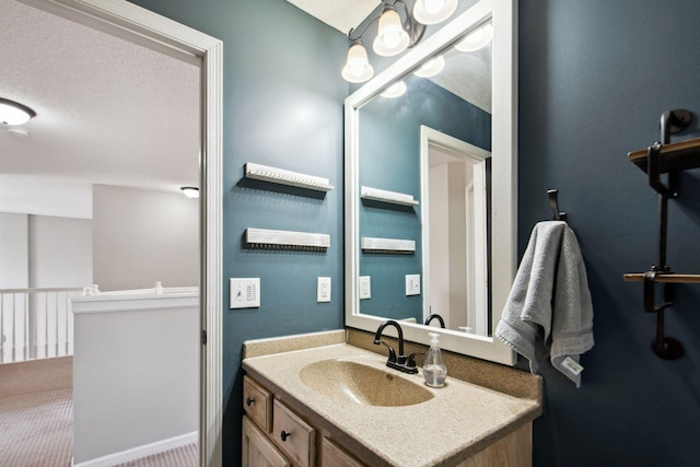 bathroom featuring a textured ceiling and vanity