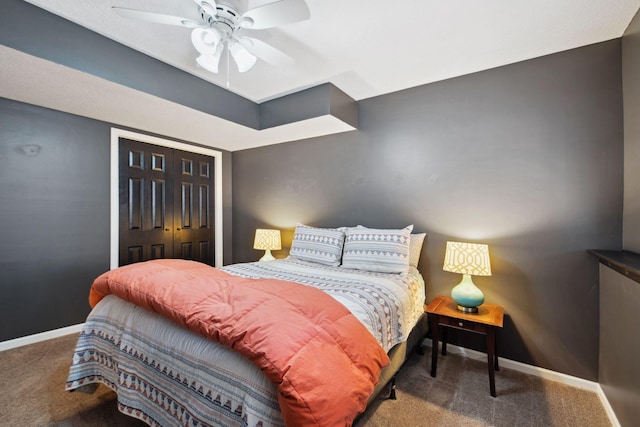 bedroom with a closet, ceiling fan, baseboards, and carpet floors