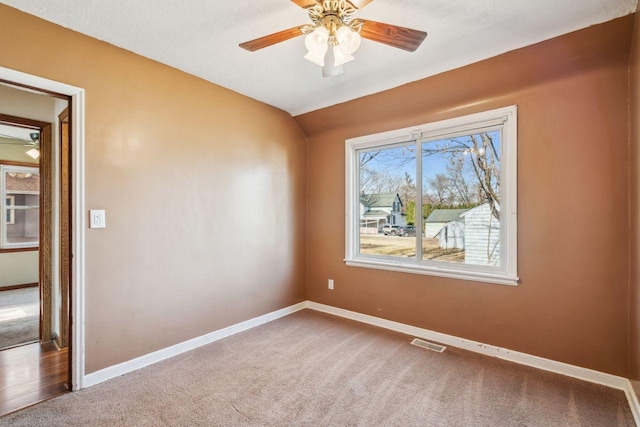 unfurnished room featuring visible vents, baseboards, and carpet floors