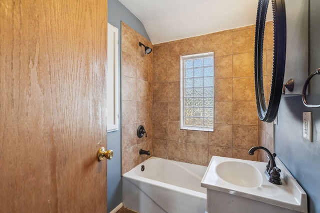 full bath with bathtub / shower combination, vaulted ceiling, and vanity