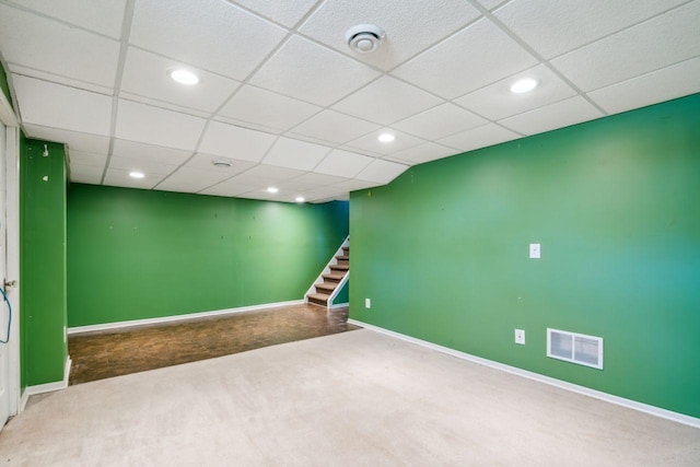 finished below grade area featuring stairway, baseboards, visible vents, carpet floors, and recessed lighting