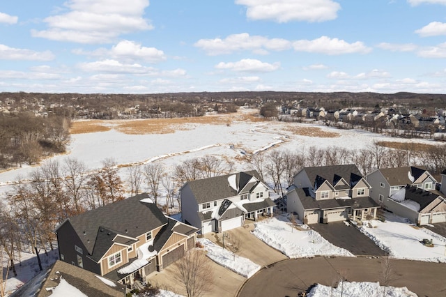 snowy aerial view with a residential view