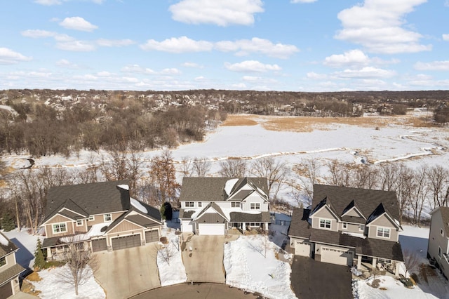 snowy aerial view with a residential view