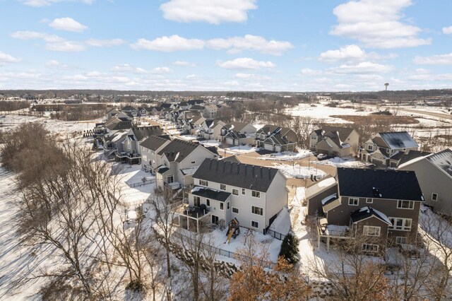 snowy aerial view featuring a residential view