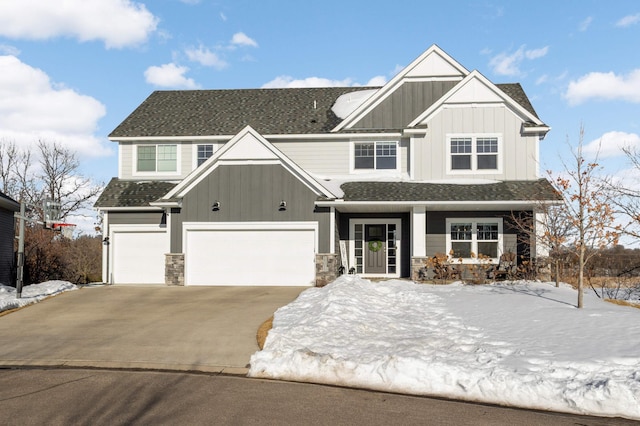 craftsman inspired home with board and batten siding, concrete driveway, roof with shingles, and a garage