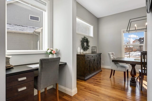 office space with baseboards and wood finished floors