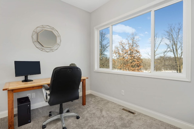 carpeted office featuring visible vents and baseboards