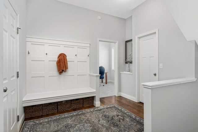 mudroom featuring dark wood finished floors and baseboards