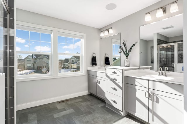 bathroom featuring a stall shower, visible vents, vanity, and baseboards