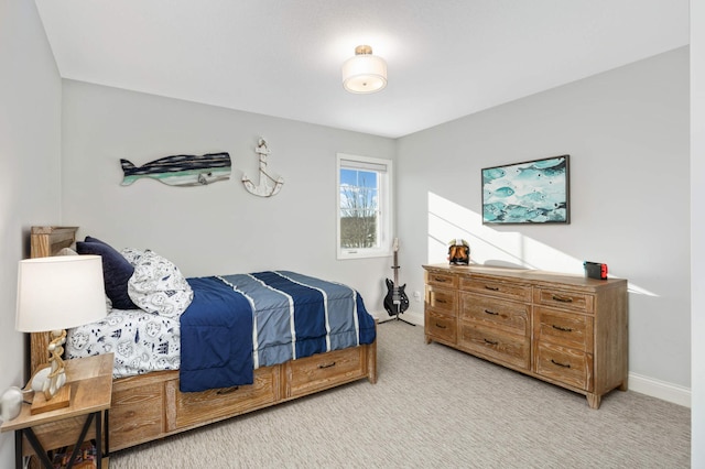 bedroom with light carpet and baseboards