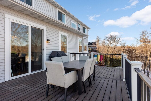 wooden deck featuring outdoor dining space and grilling area