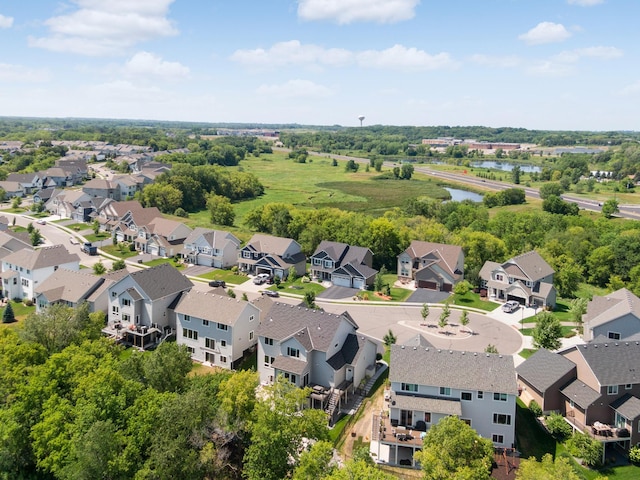 drone / aerial view with a residential view and a water view