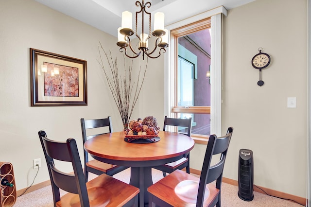 dining area featuring baseboards and an inviting chandelier