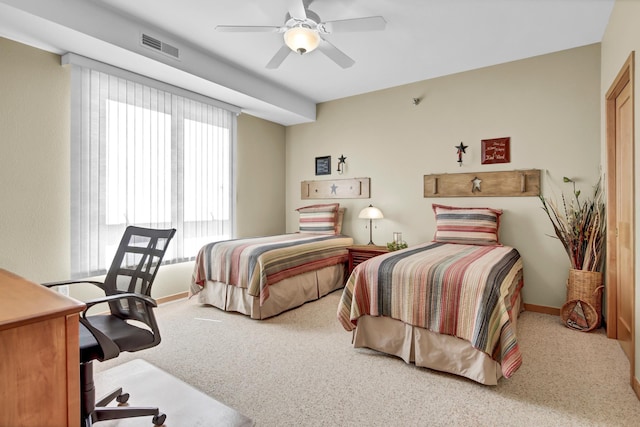 carpeted bedroom featuring visible vents, baseboards, and a ceiling fan