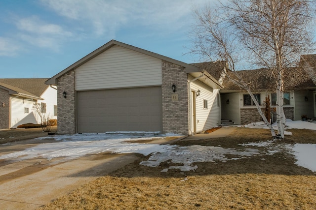 view of front of home with brick siding and an attached garage