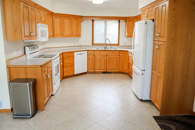 kitchen with visible vents, white appliances, light countertops, and a sink