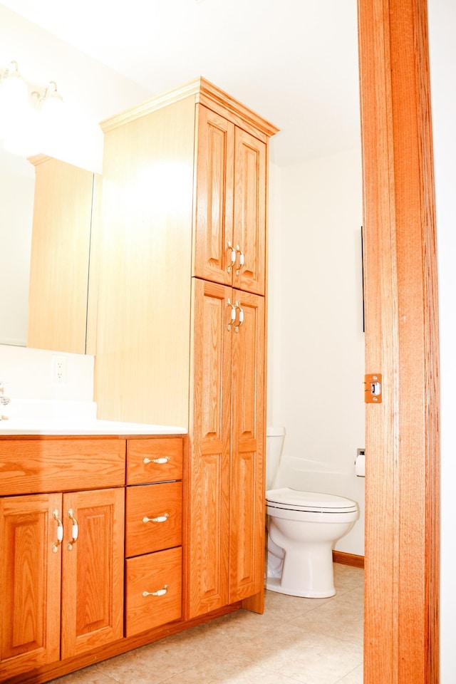 bathroom featuring vanity, toilet, and tile patterned flooring