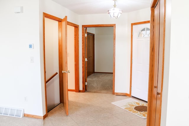 corridor featuring baseboards and visible vents