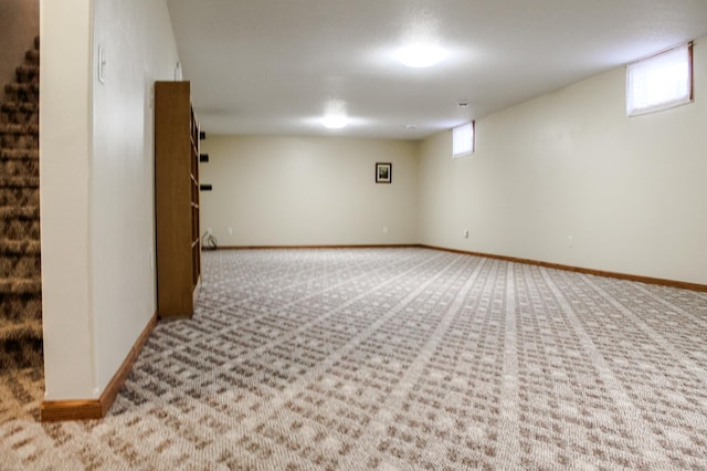 basement featuring baseboards and carpet floors