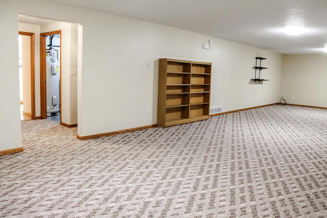 carpeted empty room featuring visible vents and baseboards