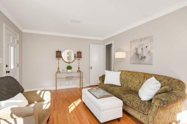 living area featuring crown molding, baseboards, and wood finished floors