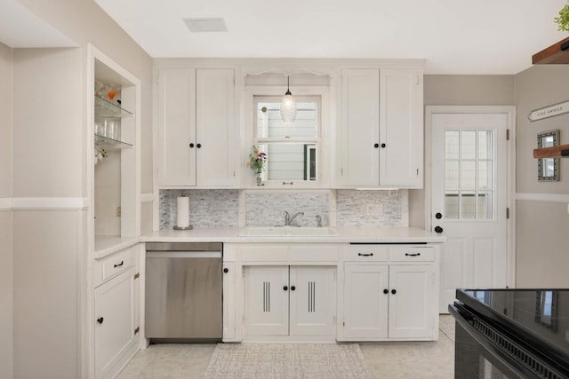 kitchen with a sink, tasteful backsplash, light countertops, and stainless steel dishwasher