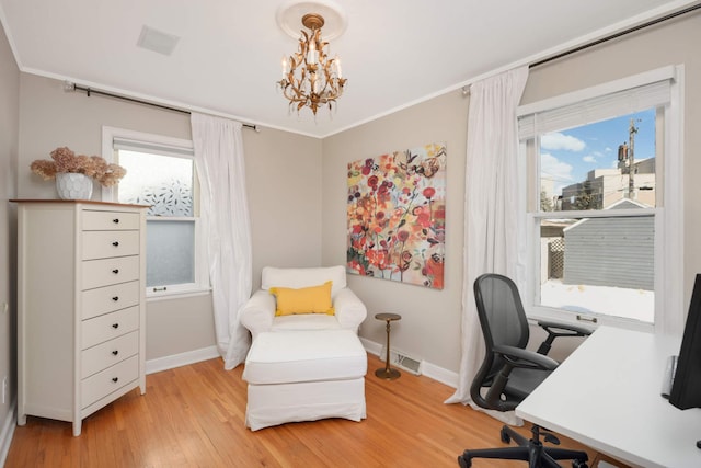 home office featuring crown molding, light wood-type flooring, a notable chandelier, and baseboards