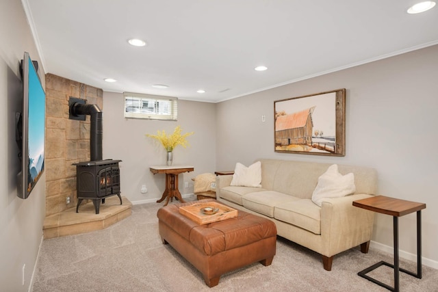 carpeted living room with a wood stove, baseboards, ornamental molding, and recessed lighting