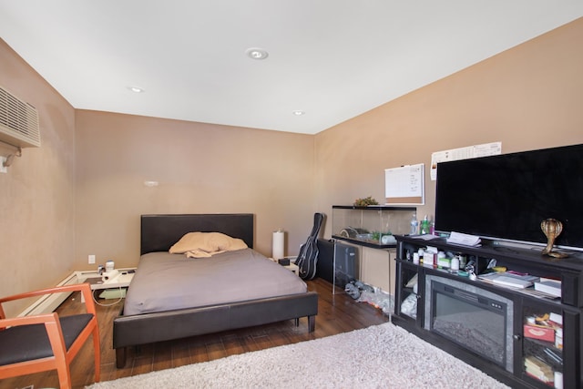 bedroom with recessed lighting and wood finished floors