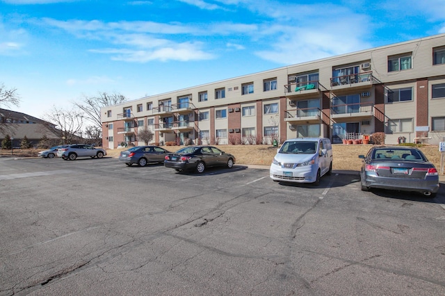 view of building exterior featuring uncovered parking