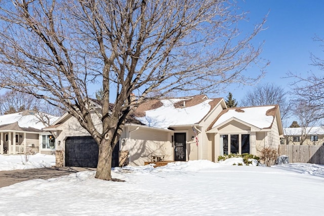 view of front of property featuring a garage and fence