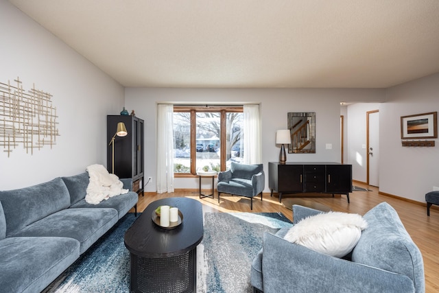 living area featuring light wood-type flooring and baseboards