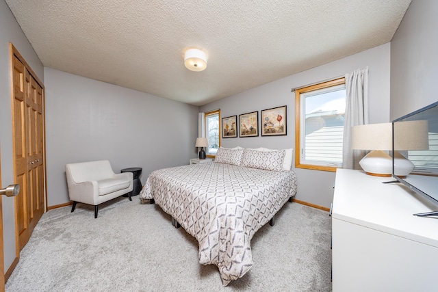 bedroom with multiple windows, a closet, and light colored carpet