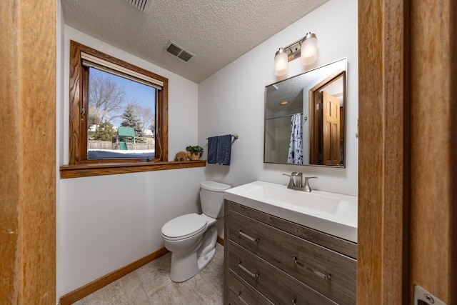 bathroom with visible vents, toilet, a textured ceiling, vanity, and baseboards