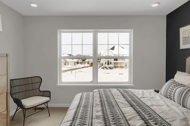 bedroom with carpet floors and baseboards