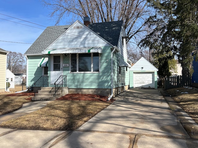 bungalow-style house with fence, roof with shingles, an outdoor structure, concrete driveway, and a chimney