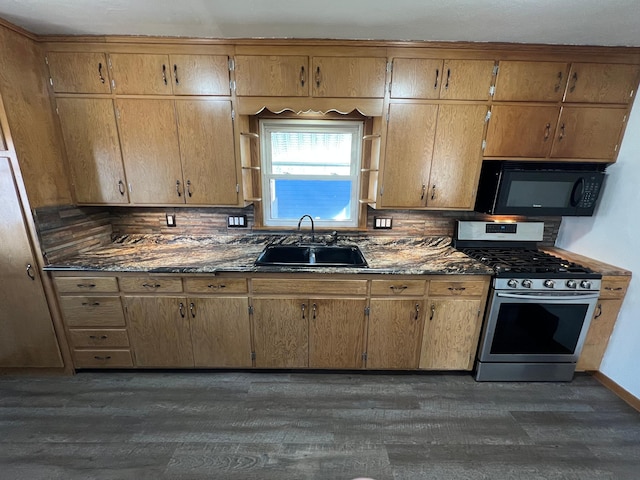 kitchen featuring stainless steel gas stove, dark wood-type flooring, black microwave, and a sink