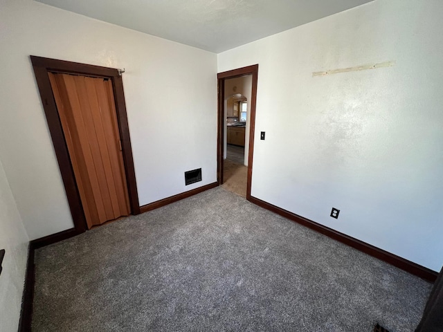 unfurnished bedroom with carpet and baseboards