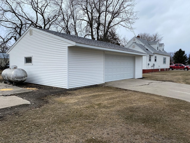 view of side of property with a garage and an outbuilding