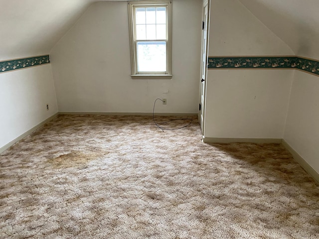 bonus room featuring carpet flooring and vaulted ceiling