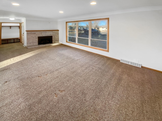 unfurnished living room with visible vents, recessed lighting, carpet, and ornamental molding