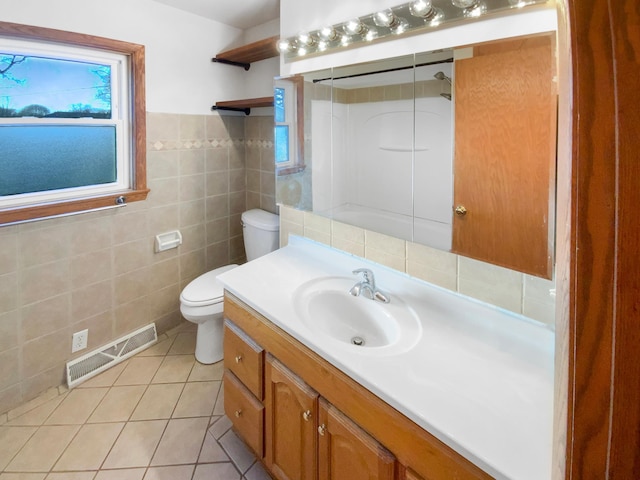 bathroom with vanity, visible vents, tile patterned floors, toilet, and tile walls