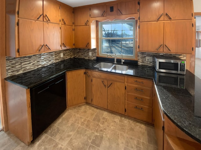 kitchen with stainless steel microwave, backsplash, dishwasher, and a sink