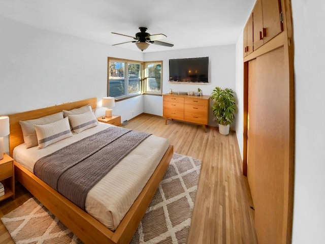 bedroom with light wood-style flooring and ceiling fan